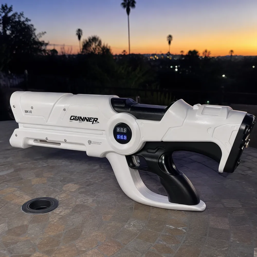 Person holding the Beam Cannon MK-V with both hands outdoors at dusk, unit pointed forward against a dark background showing full silhouette and scale