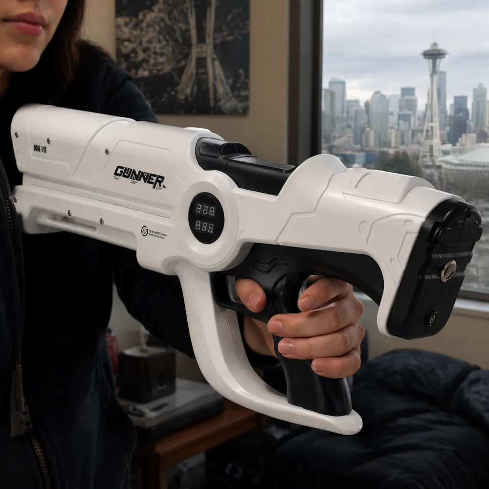 Close-up of the rear side of the Beam Cannon MK-V showing the circular two-row numeric display and the trigger area, with hands near the grip